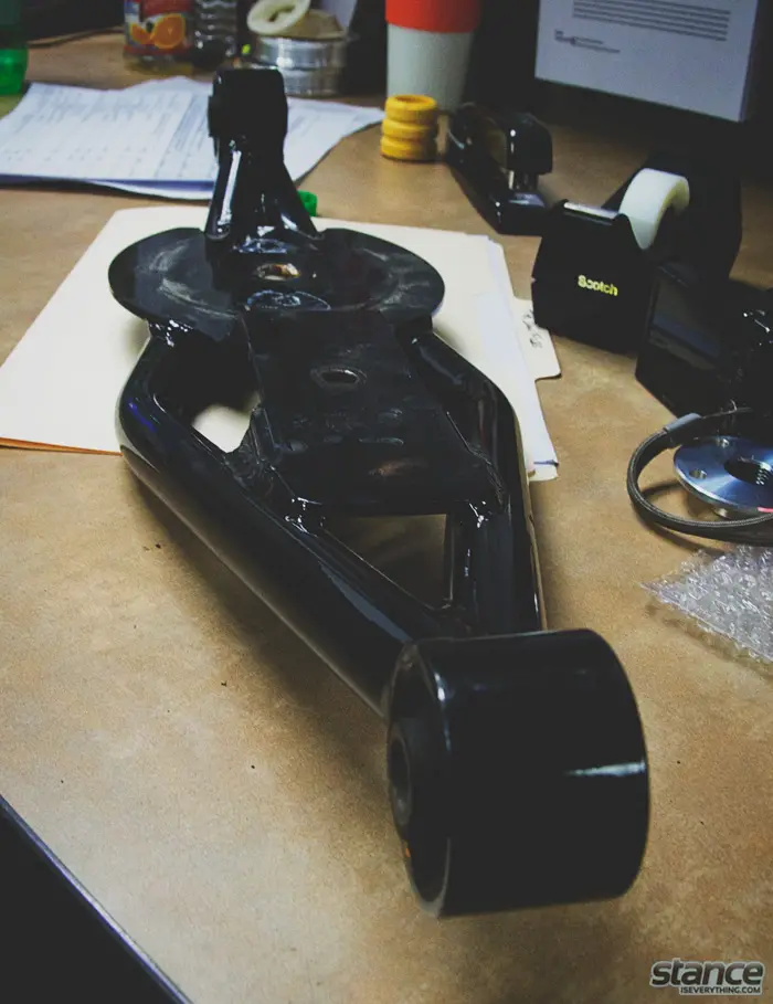 A Mazda 3 prototype trailing arm on Ian's desk